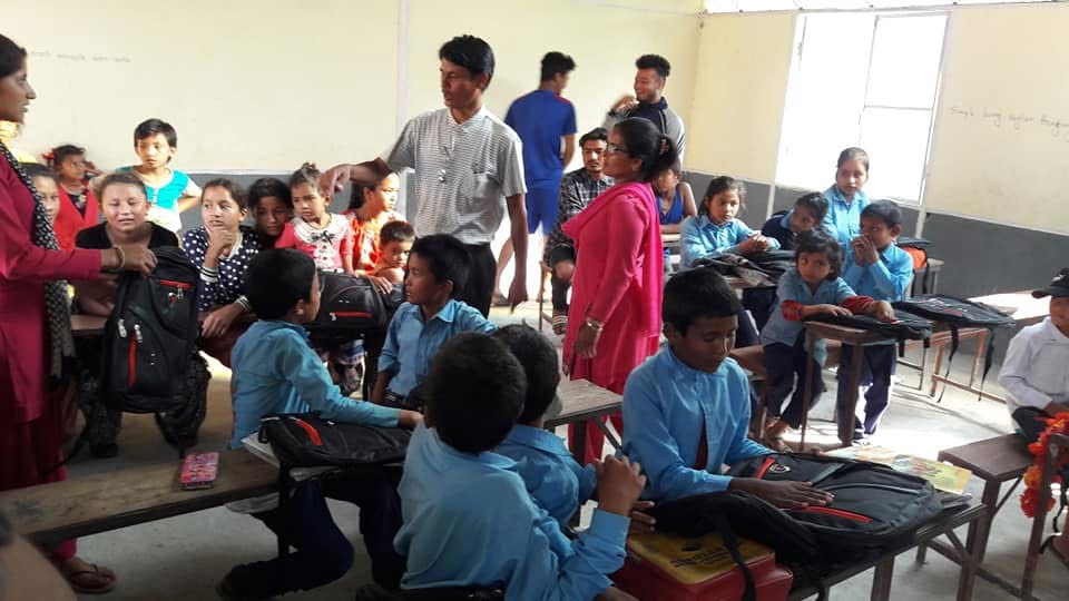 Saran Adhikari with school children